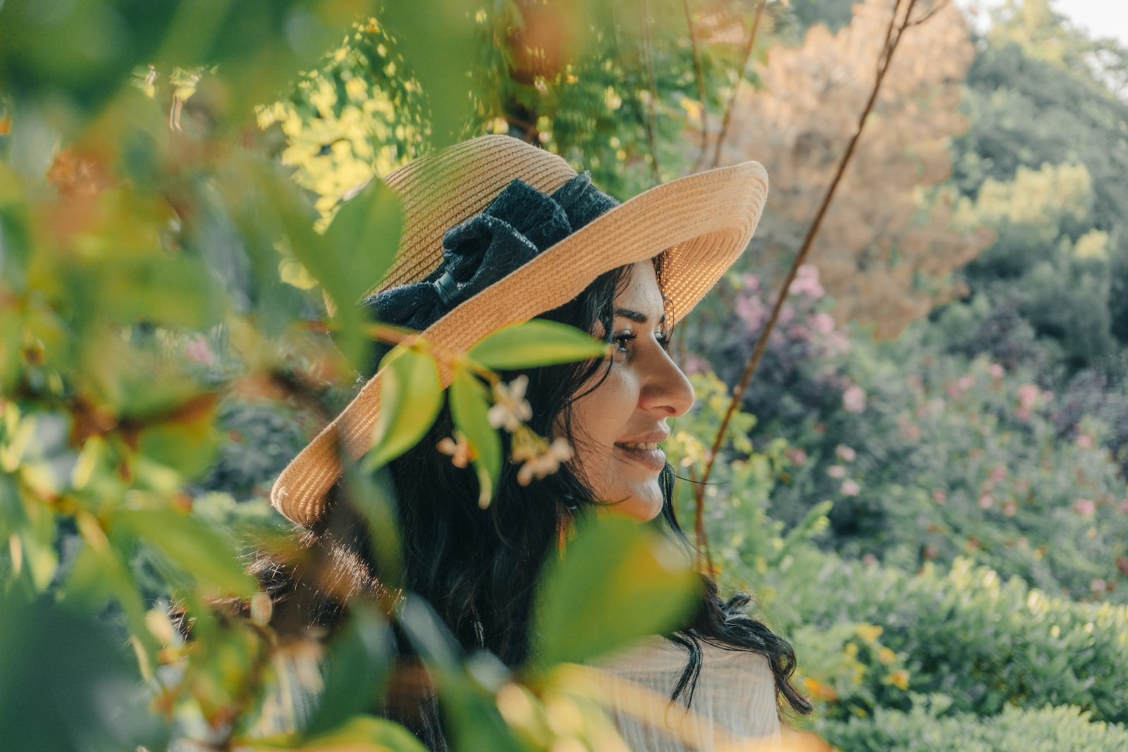 Woman in a wide straw hat in the shade, as sun exposure is a common lupus flare trigger