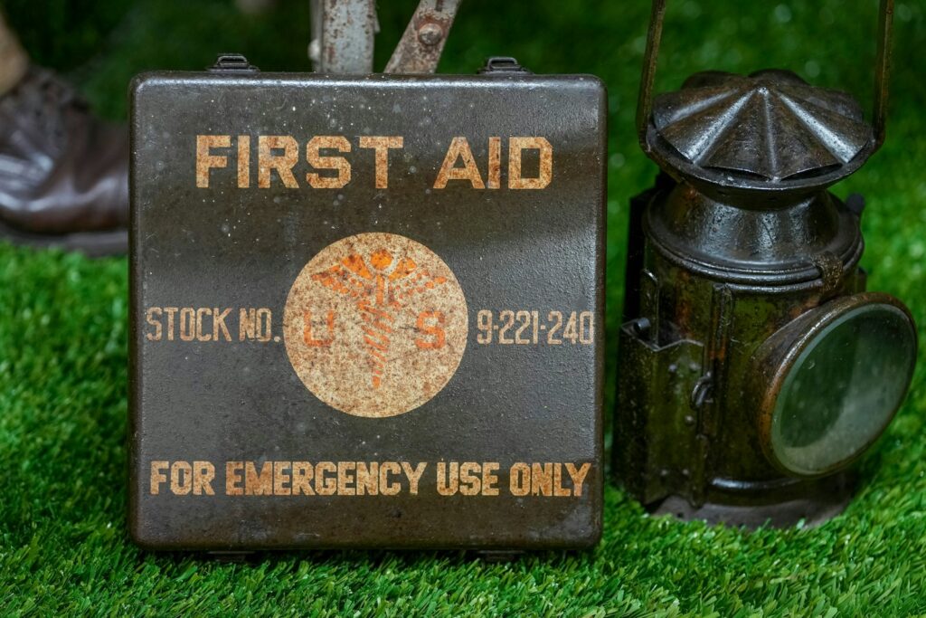 First aid kit resting on green grass