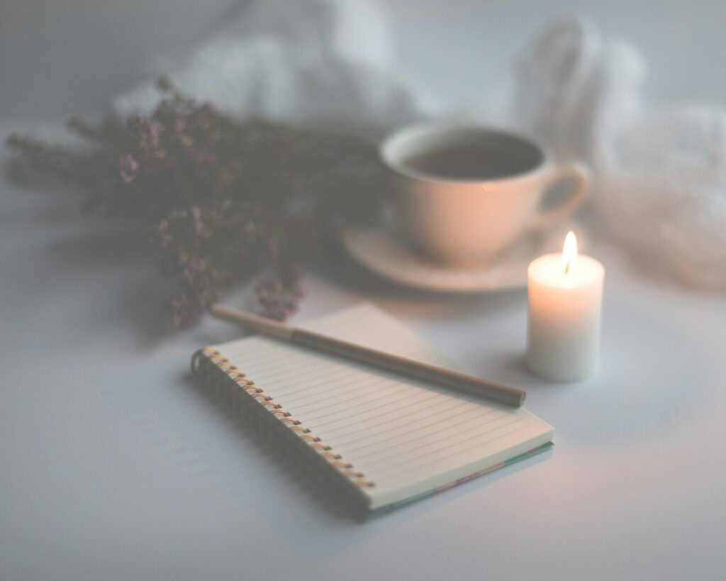 Hand writing in an open notebook journal